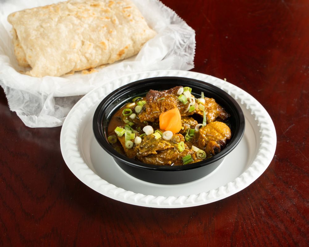 Curry duck with roti and a wiri wiri pepper